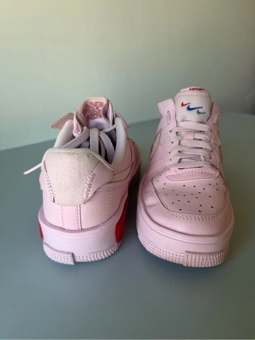 Nike Air Force 1 Women’s Light Pink Low-Top Sneakers with Red Accent